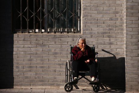 An elderly lady sits in a wheelchair in Beijing, October 16, 2013. REUTERS/Petar Kujundzic An elderly lady sits in a wheelchair in Beijing, October 16, 2013. REUTERS/Petar Kujundzic