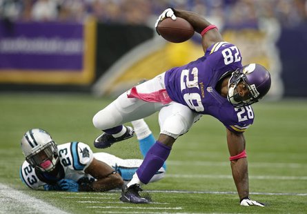 Oct 13, 2013; Minneapolis, MN, USA; Minnesota Vikings running back Adrian Peterson (28) breaks the tackle of Carolina Panthers cornerback Me Oct 13, 2013; Minneapolis, MN, USA; Minnesota Vikings running back Adrian Peterson (28) breaks the tackle of Carolina Panthers cornerback Me