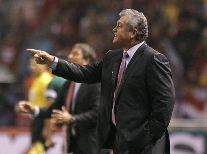 Mexico's coach Victor Manuel Vucetich (R) gives instructions to his players during their 2014 World Cup qualifying soccer match against Cost Mexico's coach Victor Manuel Vucetich (R) gives instructions to his players during their 2014 World Cup qualifying soccer match against Cost