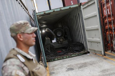 A police officer stands guard at a container holding arms seized from the North Korean flagged ship "Chong Chon Gang" at the Manzanillo Cont A police officer stands guard at a container holding arms seized from the North Korean flagged ship "Chong Chon Gang" at the Manzanillo Cont