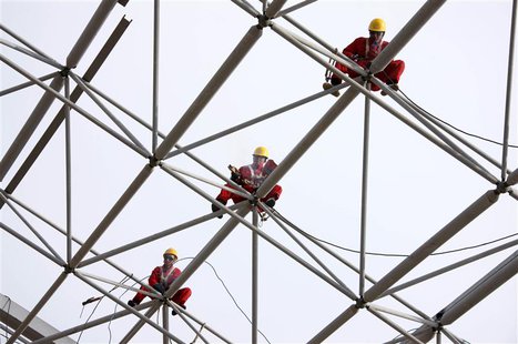 Workers set up scaffolding at a construction site in Huaibei, Anhui province, October 16, 2013. REUTERS/Stringer Workers set up scaffolding at a construction site in Huaibei, Anhui province, October 16, 2013. REUTERS/Stringer