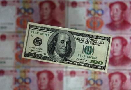 A photo illustration shows a $100 banknote placed above Chinese 100 yuan banknotes in Beijing May 10, 2013. REUTERS/Petar Kujundzic A photo illustration shows a $100 banknote placed above Chinese 100 yuan banknotes in Beijing May 10, 2013. REUTERS/Petar Kujundzic