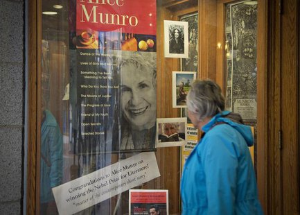 A customer looks at a window display congratulating Canadian author Alice Munro at bookstore Munro's Books after she won the Nobel Prize for A customer looks at a window display congratulating Canadian author Alice Munro at bookstore Munro's Books after she won the Nobel Prize for