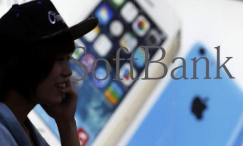 A pedestrian using a mobile phone walks past a shop window of Japan's mobile phone operator Softbank in Tokyo, September 20, 2013. REUTERS/Y A pedestrian using a mobile phone walks past a shop window of Japan's mobile phone operator Softbank in Tokyo, September 20, 2013. REUTERS/Y