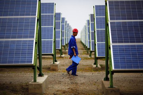 A worker inspects solar panels at a solar farm in Dunhuang, 950km (590 miles) northwest of Lanzhou, Gansu Province September 16, 2013. REUTE A worker inspects solar panels at a solar farm in Dunhuang, 950km (590 miles) northwest of Lanzhou, Gansu Province September 16, 2013. REUTE