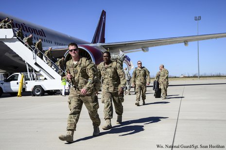 Members of the Wisconsin Army National Guard's Battery B, 1st Battalion, 121st Field Artillery arrive at Fort Bliss, Texas Oct. 11 following a combat deployment to Afghanistan. (Photo by: WI National Guard/Sgt. Sean Huolihan). Members of the Wisconsin Army National Guard's Battery B, 1st Battalion, 121st Field Artillery arrive at Fort Bliss, Texas Oct. 11 following a combat deployment to Afghanistan. (Photo by: WI National Guard/Sgt. Sean Huolihan).