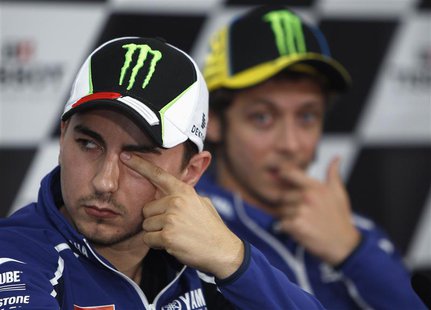 Yamaha MotoGP rider Jorge Lorenzo of Spain (L) rubs his eye as his teammate Valentino Rossi of Italy watches during the post-qualifying news Yamaha MotoGP rider Jorge Lorenzo of Spain (L) rubs his eye as his teammate Valentino Rossi of Italy watches during the post-qualifying news