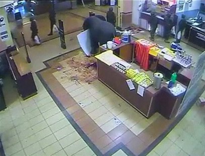 A still image taken from CCTV footage, obtained by Reuters on October 19, 2013, shows what appears to be soldiers carrying plastic shopping A still image taken from CCTV footage, obtained by Reuters on October 19, 2013, shows what appears to be soldiers carrying plastic shopping