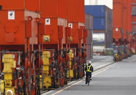 A man rides a bicycle past containers at a port in Tokyo October 21, 2013. REUTERS/Issei Kato A man rides a bicycle past containers at a port in Tokyo October 21, 2013. REUTERS/Issei Kato