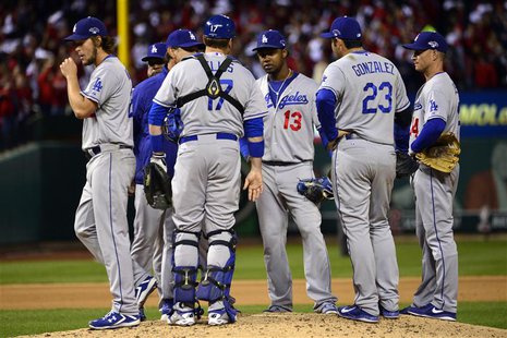 Oct 18, 2013; St. Louis, MO, USA; Los Angeles Dodgers starting pitcher Clayton Kershaw (left) walks back to the dugout after being relieved Oct 18, 2013; St. Louis, MO, USA; Los Angeles Dodgers starting pitcher Clayton Kershaw (left) walks back to the dugout after being relieved