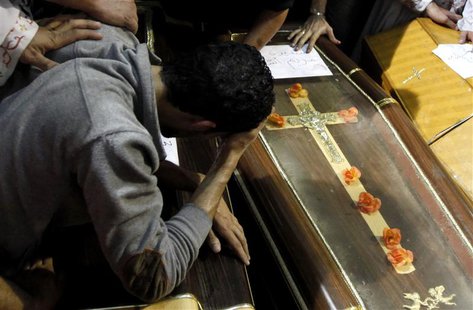 A relative mourns during the funeral for four victims killed in an attack at a wedding on Sunday, at Virgin Church in Cairo October 21, 2013 A relative mourns during the funeral for four victims killed in an attack at a wedding on Sunday, at Virgin Church in Cairo October 21, 2013