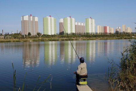 A resident fishes at a lake near apartment blocks in Beijing October 20, 2013. REUTERS/Jason Lee A resident fishes at a lake near apartment blocks in Beijing October 20, 2013. REUTERS/Jason Lee