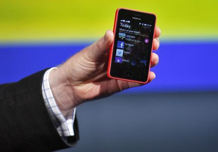 A Nokia official displays a new $99 phone in its mid-range Asha line at a launch in New Delhi May 9, 2013. REUTERS/Anindito Mukherjee A Nokia official displays a new $99 phone in its mid-range Asha line at a launch in New Delhi May 9, 2013. REUTERS/Anindito Mukherjee