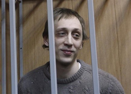 Dancer Pavel Dmitrichenko looks out from the defendant's holding cell during a hearing in Moscow October 22, 2013. REUTERS/Maxim Shemetov Dancer Pavel Dmitrichenko looks out from the defendant's holding cell during a hearing in Moscow October 22, 2013. REUTERS/Maxim Shemetov