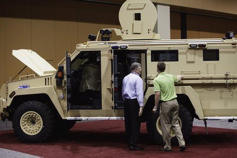 Attendees look at the Lenco MRAP Bear SWAT Team vehicle at the 7th annual Border Security Expo in Phoenix, Arizona March 12, 2013. REUTERS/J Attendees look at the Lenco MRAP Bear SWAT Team vehicle at the 7th annual Border Security Expo in Phoenix, Arizona March 12, 2013. REUTERS/J