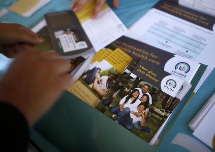 People sign up for health insurance information at a Covered California event which marks the opening of the state's Affordable Healthcare A People sign up for health insurance information at a Covered California event which marks the opening of the state's Affordable Healthcare A