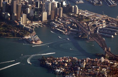 The Sydney Harbour Bridge casts a shadow next to the Sydney Opera House and central business district (CBD) as boats make their way along th The Sydney Harbour Bridge casts a shadow next to the Sydney Opera House and central business district (CBD) as boats make their way along th
