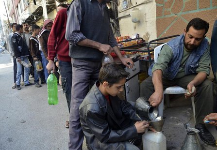 Civilians carry bottles as they queue to buy petrol in eastern al-Ghouta, near Damascus, October 22, 2013. REUTERS/Msallam Abd Albaset Civilians carry bottles as they queue to buy petrol in eastern al-Ghouta, near Damascus, October 22, 2013. REUTERS/Msallam Abd Albaset
