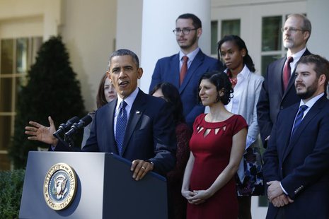 U.S. President Barack Obama stands with Affordable Care act registrants and beneficiaries as he speaks about healthcare from the Rose Garden U.S. President Barack Obama stands with Affordable Care act registrants and beneficiaries as he speaks about healthcare from the Rose Garden