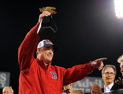 Boston Red Sox manager John Farrell holds the American League championship trophy after defeating the Detroit Tigers in game six of the Amer Boston Red Sox manager John Farrell holds the American League championship trophy after defeating the Detroit Tigers in game six of the Amer