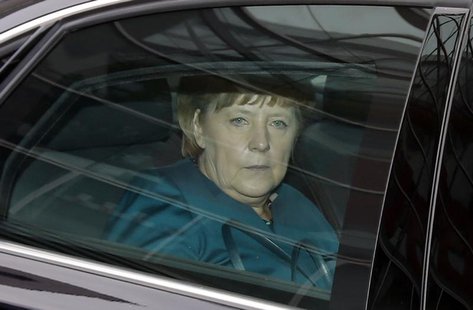 German Chancellor and leader of the Christian Democratic Union (CDU) Angela Merkel sits in her limousine as she leaves the first round of co German Chancellor and leader of the Christian Democratic Union (CDU) Angela Merkel sits in her limousine as she leaves the first round of co