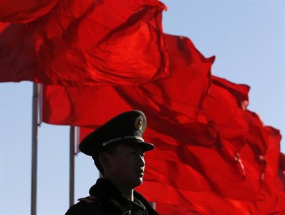 A paramilitary policeman stands guard at Tiananmen Square near the Great Hall of the People prior to the pre-session of the National People' A paramilitary policeman stands guard at Tiananmen Square near the Great Hall of the People prior to the pre-session of the National People'