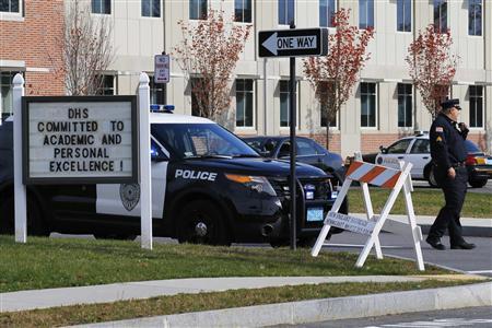 A police officer guards the entrance to the high school in Danvers, Massachusetts October 23, 2013. A 14-year-old student at a suburban high school outside Boston was in custody Wednesday after police found the body of a teacher in the woods behind the school overnight, officials said.
REUTERS/Brian Snyder A police officer guards the entrance to the high school in Danvers, Massachusetts October 23, 2013. A 14-year-old student at a suburban high school outside Boston was in custody Wednesday after police found the body of a teacher in the woods behind the school overnight, officials said.
REUTERS/Brian Snyder