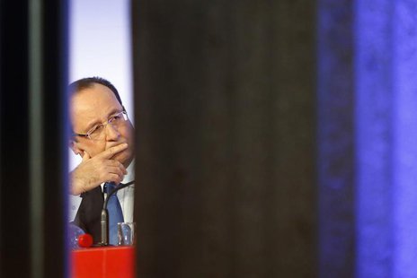 France's President Francois Hollande listens to a speech during a meeting called "Reporters of Hopes, Solutions for France" at Iena Palace i France's President Francois Hollande listens to a speech during a meeting called "Reporters of Hopes, Solutions for France" at Iena Palace i