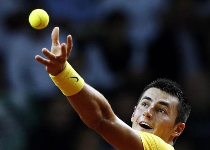 Australia's Bernard Tomic serves the ball to Poland's Lukasz Kubot during their Davis Cup play-off tennis match in Warsaw September 15, 2013 Australia's Bernard Tomic serves the ball to Poland's Lukasz Kubot during their Davis Cup play-off tennis match in Warsaw September 15, 2013