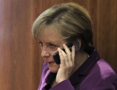 Germany's Chancellor Angela Merkel uses her mobile phone before a meeting at a European Union summit in Brussels in this December 9, 2011 fi Germany's Chancellor Angela Merkel uses her mobile phone before a meeting at a European Union summit in Brussels in this December 9, 2011 fi