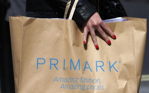 A shopper passes demonstrators outside clothing retailer Primark in London April 27, 2013. REUTERS/Suzanne Plunkett A shopper passes demonstrators outside clothing retailer Primark in London April 27, 2013. REUTERS/Suzanne Plunkett