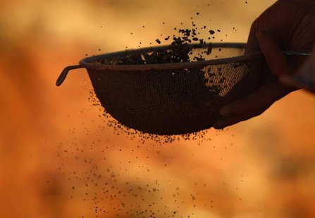 A geologist refines an iron ore core sample before cataloguing it at an Atlas Iron Limited's prospective iron ore mine site near Port Hedlan A geologist refines an iron ore core sample before cataloguing it at an Atlas Iron Limited's prospective iron ore mine site near Port Hedlan