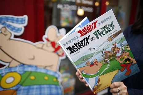 A woman poses with the new comic book "Asterix chez les Pictes" (Asterix and the Picts), written by French author Jean-Yves Ferri and illust A woman poses with the new comic book "Asterix chez les Pictes" (Asterix and the Picts), written by French author Jean-Yves Ferri and illust
