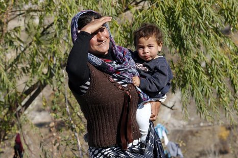 A Syrian refugee carries her baby in central Ankara October 20, 2013. REUTERS/Umit Bektas A Syrian refugee carries her baby in central Ankara October 20, 2013. REUTERS/Umit Bektas