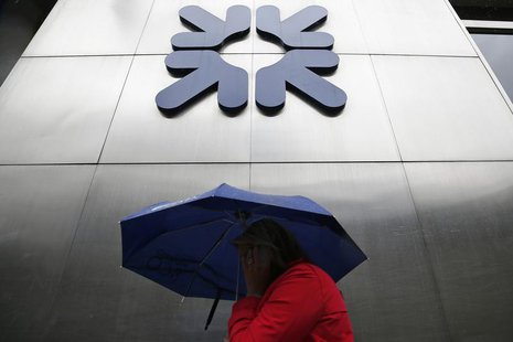 A woman shelters under an umbrella as she walks past a branch of the Royal Bank of Scotland in the City of London September 17, 2013. REUTER A woman shelters under an umbrella as she walks past a branch of the Royal Bank of Scotland in the City of London September 17, 2013. REUTER