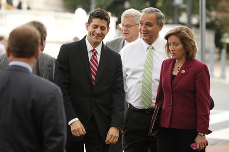 U.S. Representative Paul Ryan (R-WI) (L) smiles and talks with fellow House Republicans as they arrive for meetings at the Republican Nation U.S. Representative Paul Ryan (R-WI) (L) smiles and talks with fellow House Republicans as they arrive for meetings at the Republican Nation
