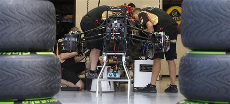 Mechanics work on the car of Lotus Formula One driver Romain Grosjean of France at the pit ahead of the Singapore F1 Grand Prix in this Sept Mechanics work on the car of Lotus Formula One driver Romain Grosjean of France at the pit ahead of the Singapore F1 Grand Prix in this Sept