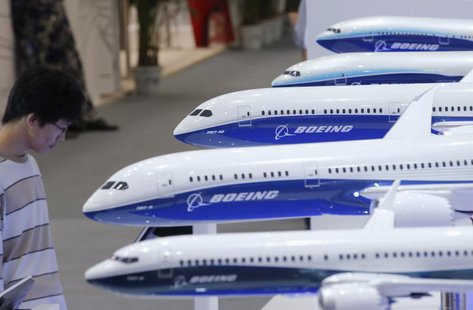 A visitor looks at a display of miniature Boeing passenger aircraft at Aviation Expo China 2013 in Beijing September 25, 2013. REUTERS/Kim K A visitor looks at a display of miniature Boeing passenger aircraft at Aviation Expo China 2013 in Beijing September 25, 2013. REUTERS/Kim K