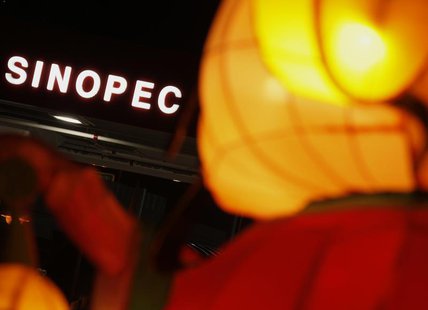 A Sinopec sign displayed at its gas station is seen behind a Chinese New Year lantern installation in Hong Kong February 5, 2013. REUTERS/Bo A Sinopec sign displayed at its gas station is seen behind a Chinese New Year lantern installation in Hong Kong February 5, 2013. REUTERS/Bo