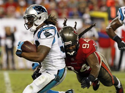Oct 24, 2013; Tampa, FL, USA; Carolina Panthers running back DeAngelo Williams (34) runs with the ball as Tampa Bay Buccaneers defensive end Oct 24, 2013; Tampa, FL, USA; Carolina Panthers running back DeAngelo Williams (34) runs with the ball as Tampa Bay Buccaneers defensive end