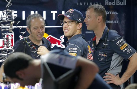 Red Bull Formula One driver Sebastian Vettel (C) of Germany looks on from inside his team garage at the Buddh International Circuit in Great Red Bull Formula One driver Sebastian Vettel (C) of Germany looks on from inside his team garage at the Buddh International Circuit in Great