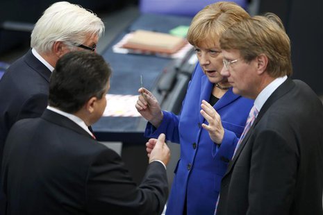 German Chancellor and leader of the Christian Democratic Union (CDU) Angela Merkel talks with Sigmar Gabriel (2nd L) leader of the Social De German Chancellor and leader of the Christian Democratic Union (CDU) Angela Merkel talks with Sigmar Gabriel (2nd L) leader of the Social De