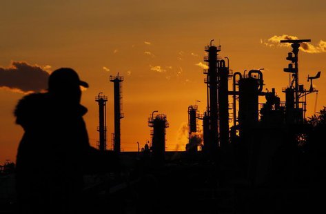 A man walks past chimneys at an industrial district during sunset in Tokyo January 31, 2011. REUTERS/Kim Kyung-Hoon A man walks past chimneys at an industrial district during sunset in Tokyo January 31, 2011. REUTERS/Kim Kyung-Hoon