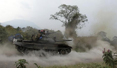 A Congolese armed forces (FARDC) tank fires a shot as soldiers battle M23 rebels in Kibati, outside Goma in the eastern Democratic Republic A Congolese armed forces (FARDC) tank fires a shot as soldiers battle M23 rebels in Kibati, outside Goma in the eastern Democratic Republic