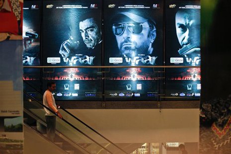 A man rides an escalator past posters of the movie "Waar" at the Atrium cinemas in Karachi October 23, 2013. REUTERS/Akhtar Soomro A man rides an escalator past posters of the movie "Waar" at the Atrium cinemas in Karachi October 23, 2013. REUTERS/Akhtar Soomro