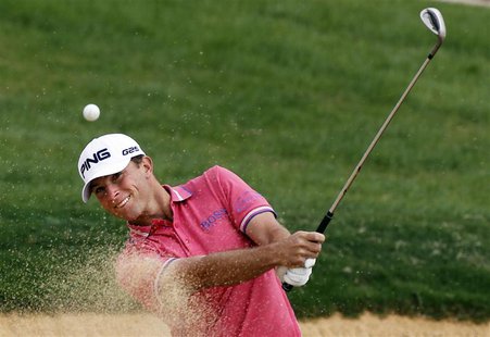 Luke Guthrie of U.S. hits out of a sand trap on the 7th hole during the BMW Masters 2013 golf tournament at Lake Malaren Golf Club in Shangh Luke Guthrie of U.S. hits out of a sand trap on the 7th hole during the BMW Masters 2013 golf tournament at Lake Malaren Golf Club in Shangh