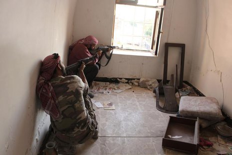 Free Syrian Army fighters take position as they aim their weapons inside a room in Bab Antakya district in Old Aleppo, October 22, 2013. Pic Free Syrian Army fighters take position as they aim their weapons inside a room in Bab Antakya district in Old Aleppo, October 22, 2013. Pic