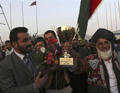 Afghan cricket team captain Mohammad Nabi Esa Khil (C) holds the ACC Cup after the team's arrival in Kabul, in this October 12, 2013 file ph Afghan cricket team captain Mohammad Nabi Esa Khil (C) holds the ACC Cup after the team's arrival in Kabul, in this October 12, 2013 file ph