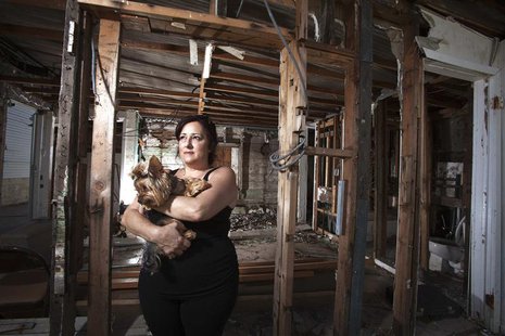 Christine Cina poses for a portrait in what is left of her house after Superstorm Sandy in the Staten Island borough of New York, September Christine Cina poses for a portrait in what is left of her house after Superstorm Sandy in the Staten Island borough of New York, September