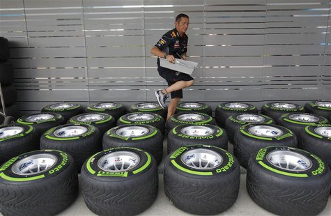 A team member walks amid Pirelli tyres outside the Red Bull garage at the Buddh International Circuit in Greater Noida on the outskirts of N A team member walks amid Pirelli tyres outside the Red Bull garage at the Buddh International Circuit in Greater Noida on the outskirts of N